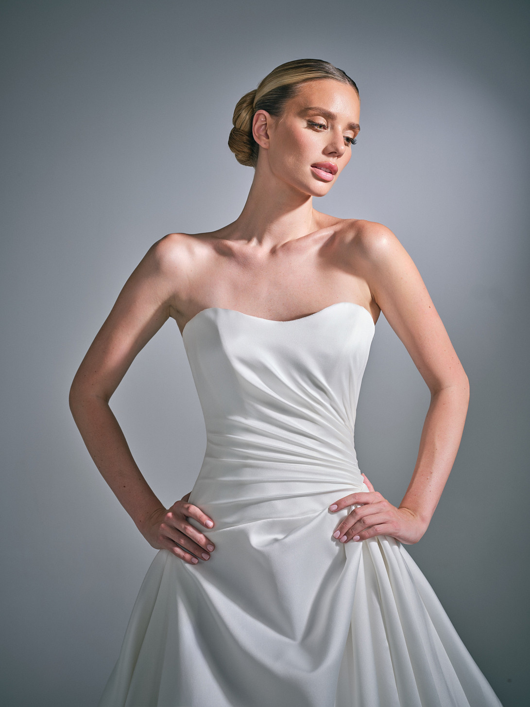 Close-up of the Cassielle wedding dress bodice, featuring a rounded scoop neckline and intricate hand-draping.