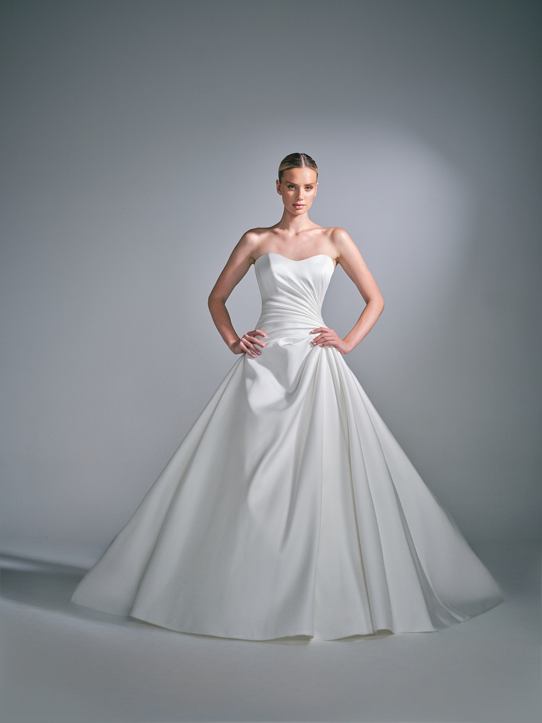 Full length back view of the Cassielle wedding gown, it also has a covered button back and sweeping Mikado ballgown skirt and Structured silhouette ·