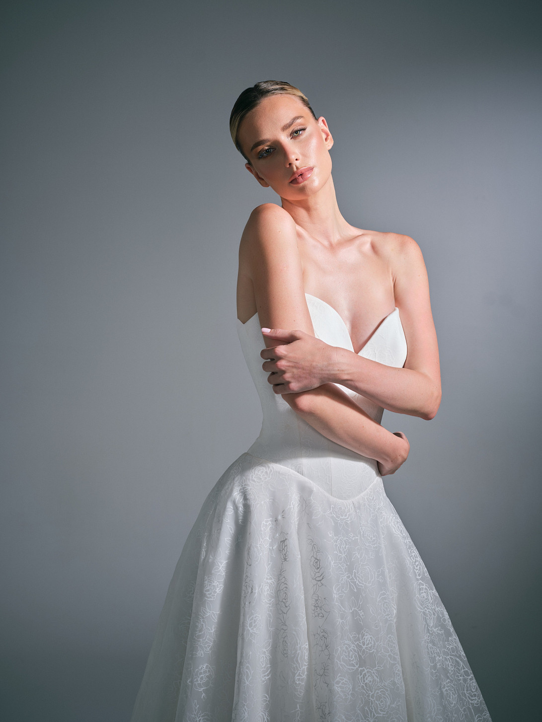 Close-up of the Clovelle bridal gown bodice, highlighting the detailed hand-draping and signature corsetry by Suzanne Neville.