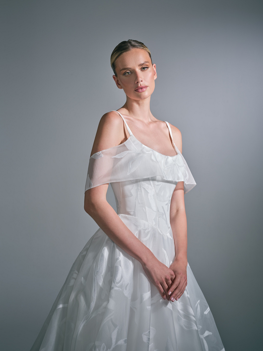 The low back is Liora wedding dress has a detachable organza collar sits softly across the shoulders, giving the dress a completely different second look