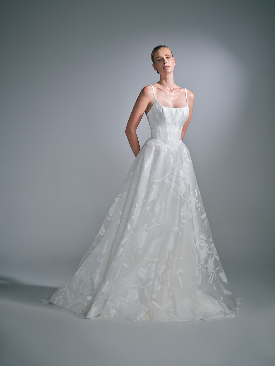 Full-length front view of the Liora wedding dress by Suzanne Neville, showcasing a sculpted bodice and modern bridal silhouette.